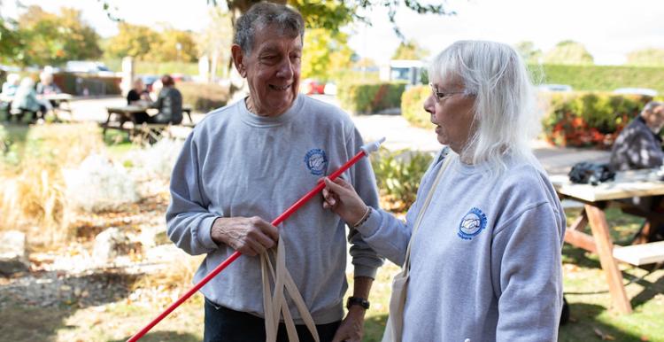 Two people outside an event chatting to each other