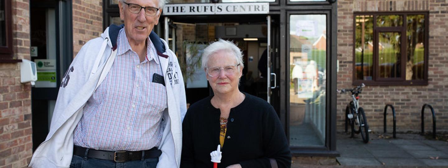 Man and a woman standing side by side outside a medical centre