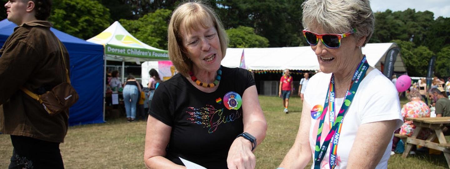 Two women looking at a leaflet together